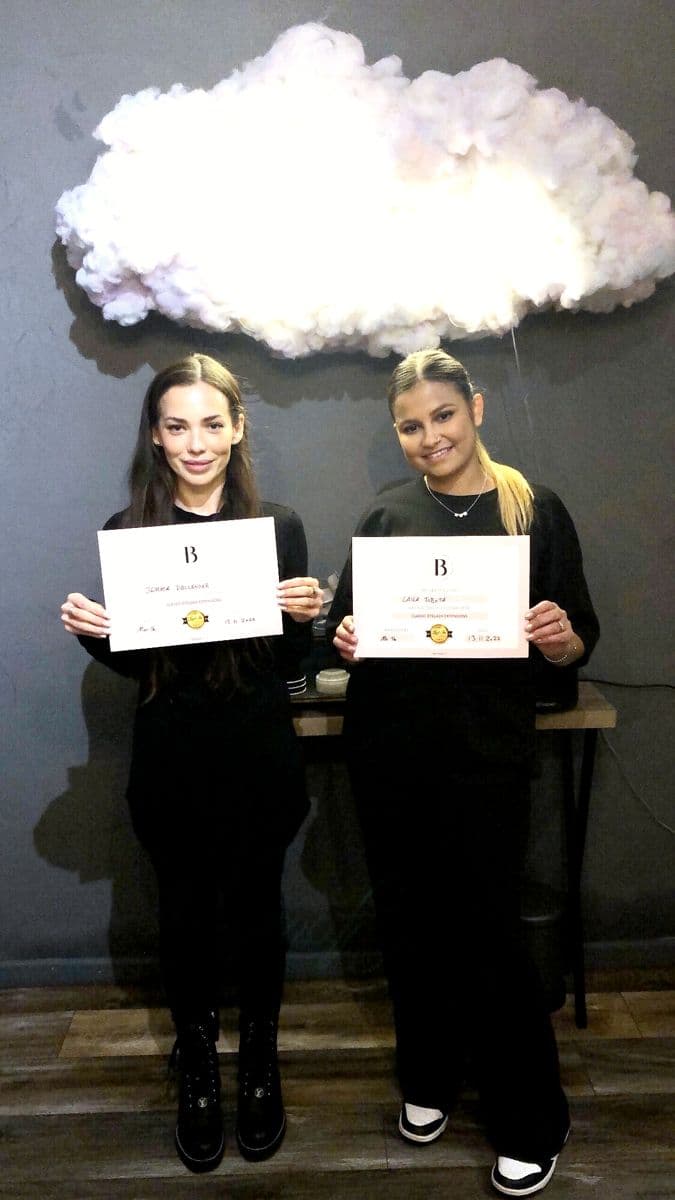 Two students with their certificates on training day