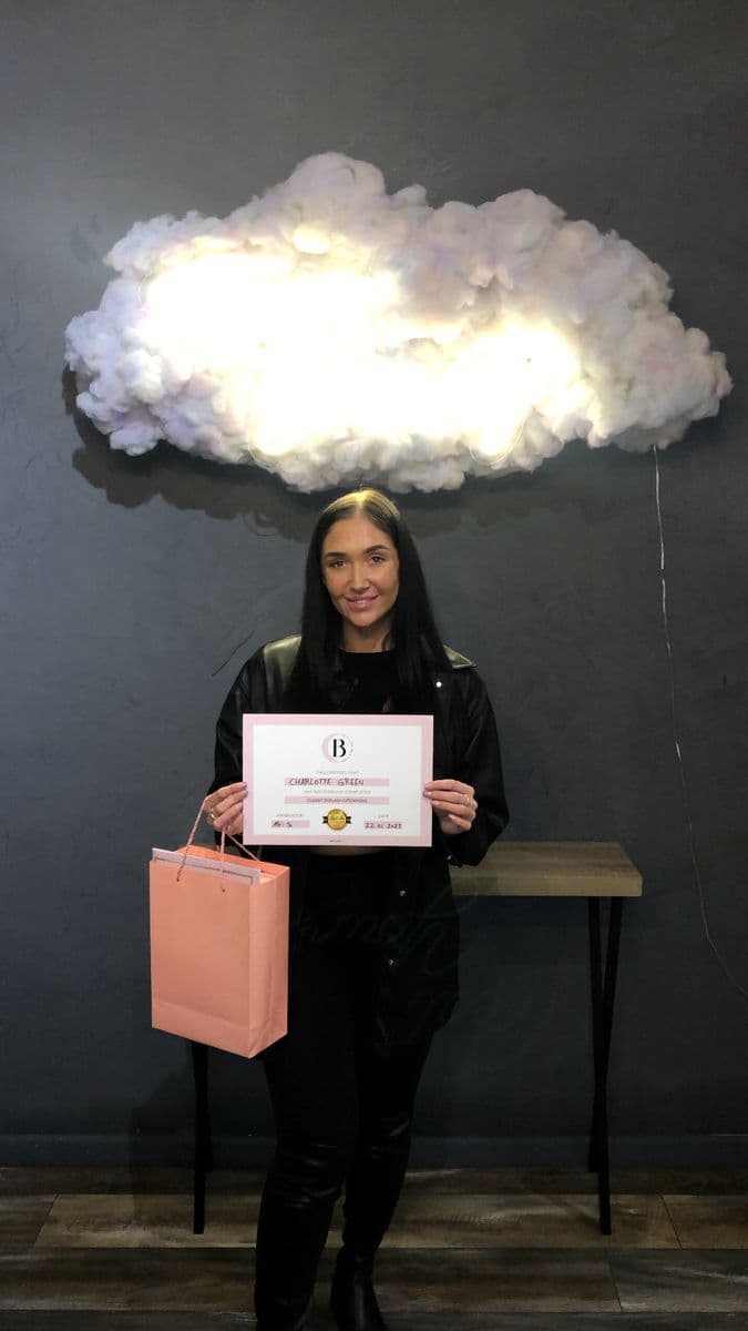 A student with her certificate and BB's Lash kit bag